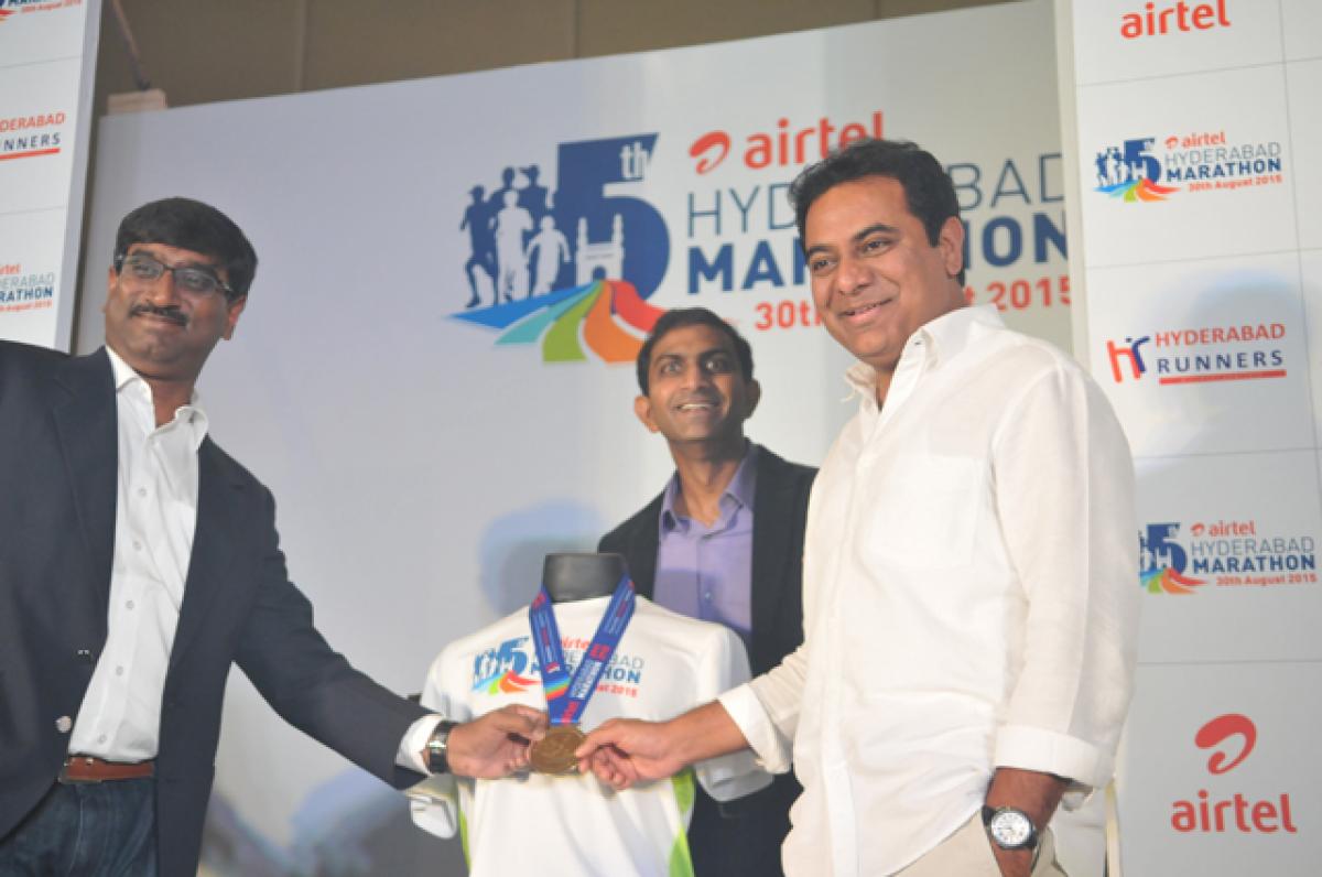 Venkatesh Vijayraghavan, Dr. Murali Nannapaneni and K. T. Rama Rao with the T-shirt and medal at the event. Photo: Hrudayanand